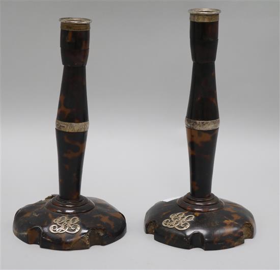 A pair of tortoiseshell and silver candlesticks